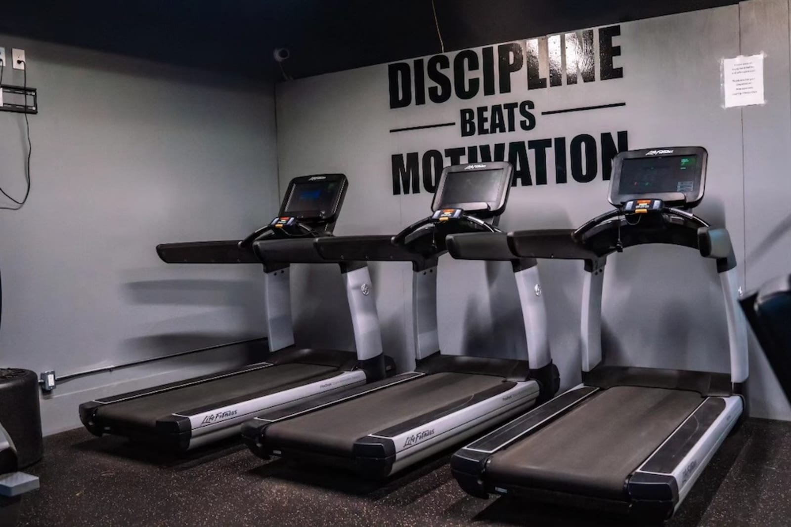 Life Fitness treadmills under the Discipline Beats Motivation wall
